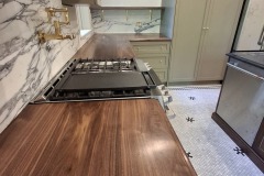 Walnut-countertop-sage-green-kitchen
