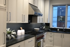 White-slim-shaker-kitchen-cabinets-stove-side